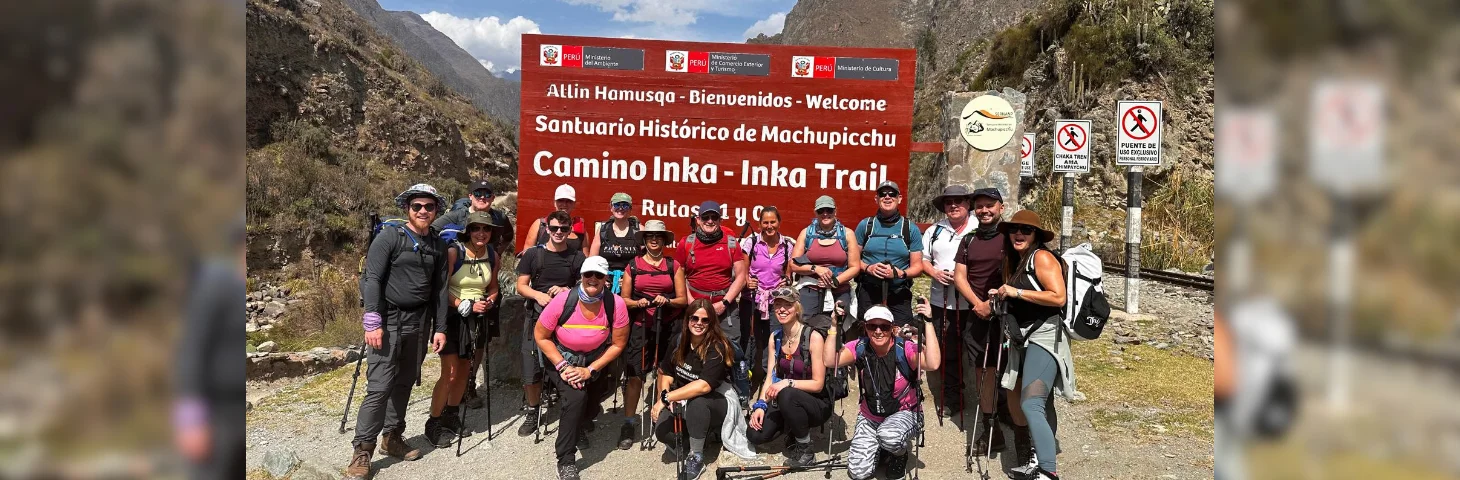 Not Just Travel consultants at a red sign on the Inca Trail in Peru.