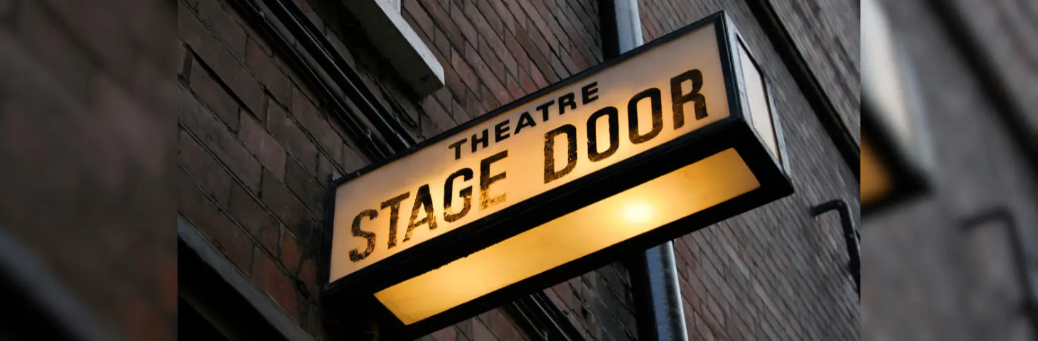 Image of a sign that says 'Theatre Stage Door'